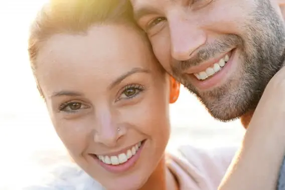 couple in happy mode showing their teeth