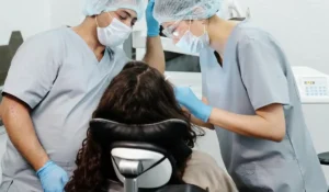 Hygienist and Dentist taking care of a patient