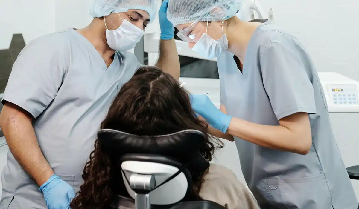 Hygienist and Dentist taking care of a patient