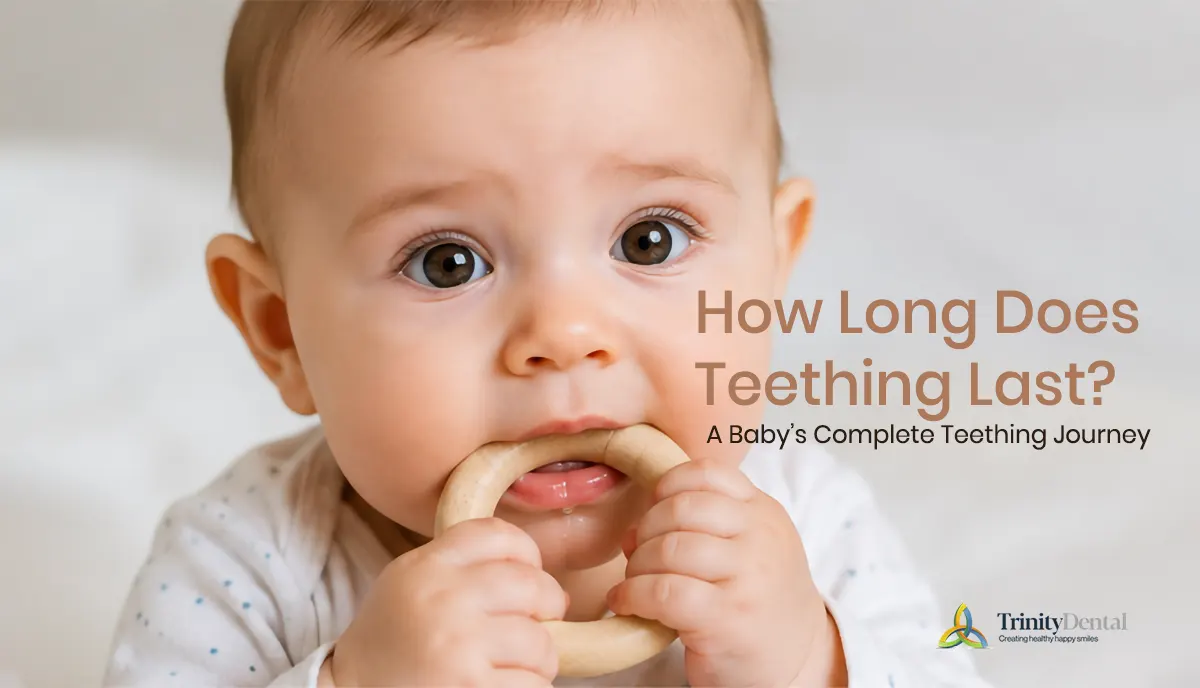 Baby chewing a teething ring while experiencing early teething symptoms